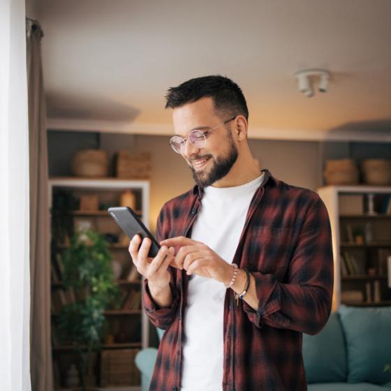 A man looking at his phone screen - My RemServ